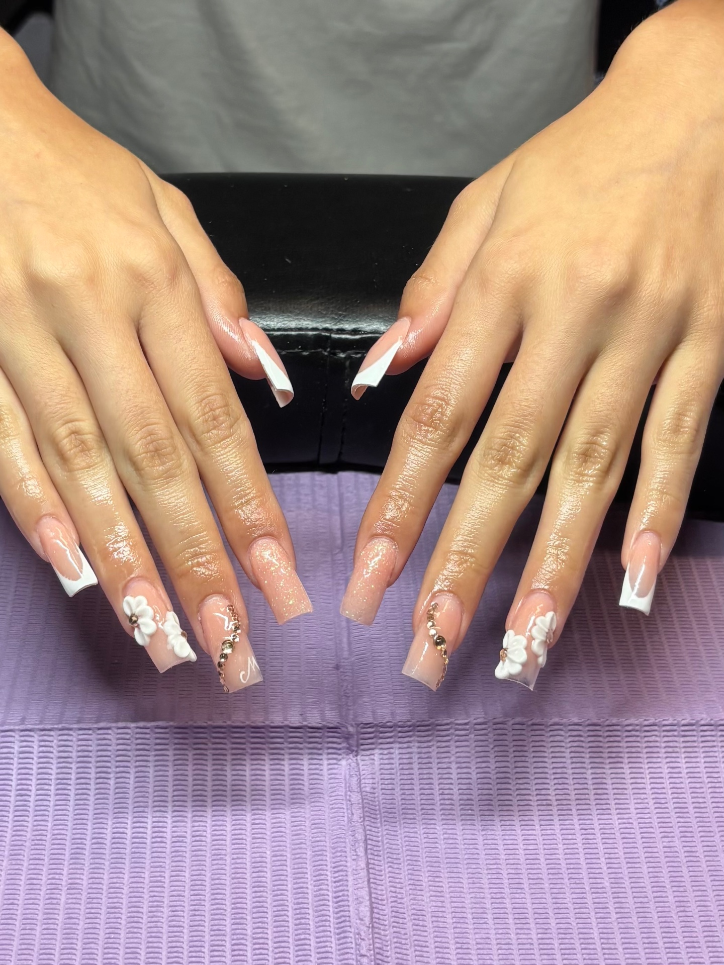 French tip nails with 3D white flowers and rose gold crystals